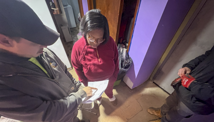 Photo of an East Hills resident meeting with Energize Pittsburgh professionals.