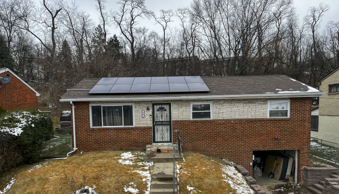Photo of a home with solar panels installed on the roof.